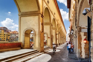 Photo of Italy Piazza Maggiore in Bologna old town tower of town hall with big clock and blue sky on background, antique buildings terracotta galleries.