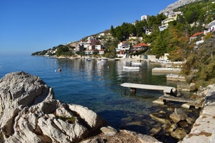 Photo of panorama and landscape of Makarska resort and its harbour with boats and blue sea water, Croatia.