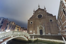 Famous buildings, gondolas and monuments by the Rialto Bridge of Venice on the Grand Canal, Italy.