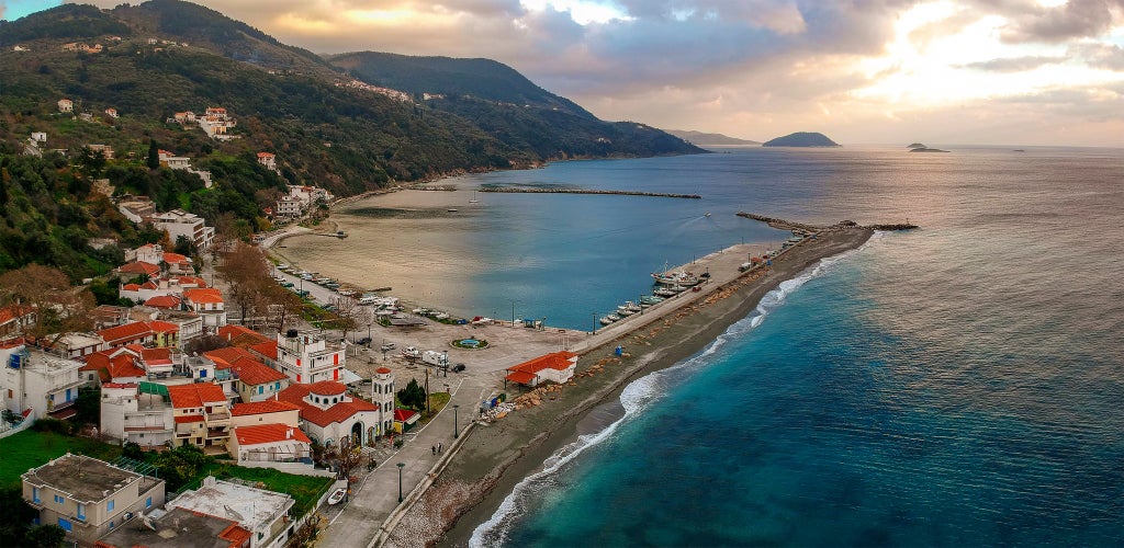 Photo of aerial view of the coastal seaside village Loutraki with it's beautiful beach, Greece.