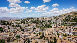 Photo of aerial view of Jaen with cathedral and Sierra Magina mountains on background, Andalusia, Spain.