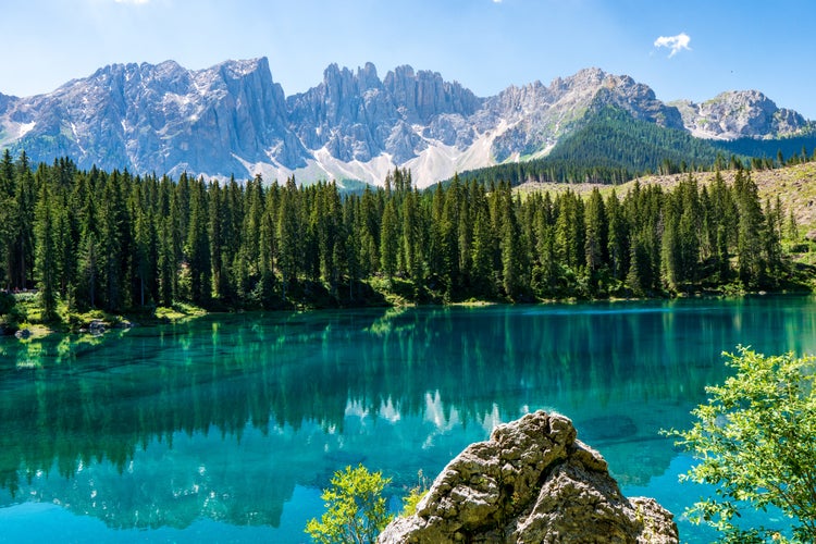 photo of view of Carezza lake (Lago di Carezza, Karersee) with Mount Latemar, Bolzano province, South Tyrol, Italy.