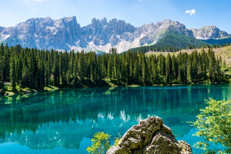 photo of view of Carezza lake (Lago di Carezza, Karersee) with Mount Latemar, Bolzano province, South Tyrol, Italy.