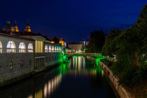 Photo of Ljubljana, Slovenia, view of the Ljubljanica River by night and the illuminated Butchers' Bridge.