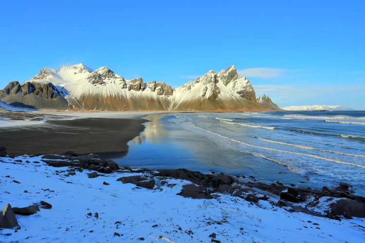 photo of view of Black sand beach and Vestrahorn Mountain, Stokksnes, east Höfn, Austurland, Höfn, Iceland.