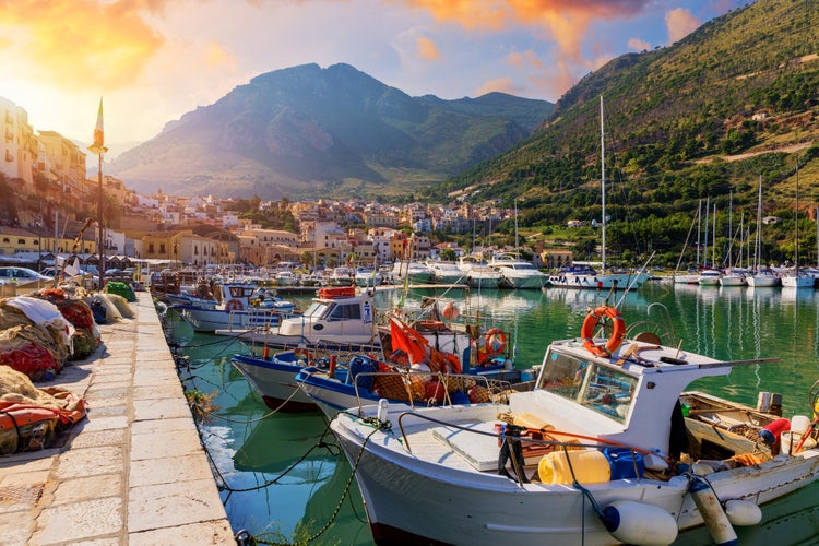 Sicilian port with fishing boats of Castellammare del Golfo village of Sicily, Trapani, Italy. Castellammare del Golfo town (Gulf of Castellammare) on Mediterranean Sea, Trapany, Sicily, Italy.