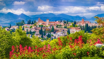 Photo of aerial view of Jaen with cathedral and Sierra Magina mountains on background, Andalusia, Spain.