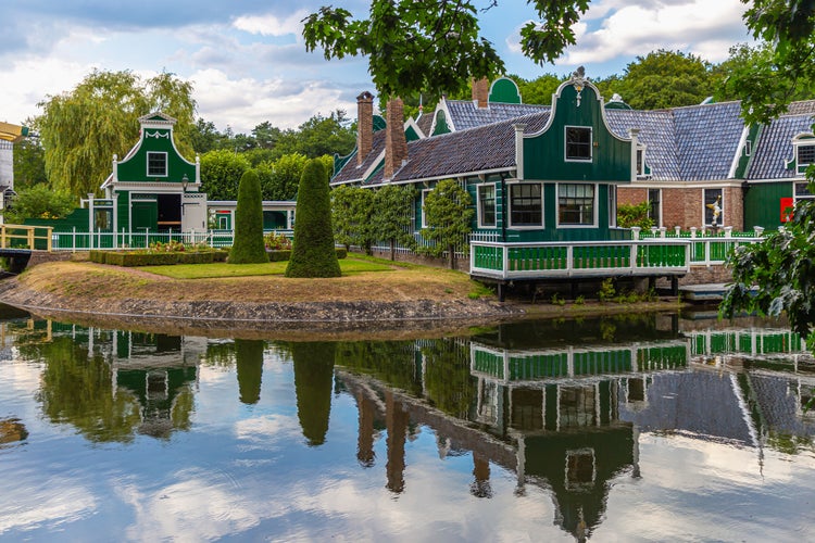 Merchant's house in Dutch Open Air Museum, Openluchtmuseum, Arnhem, Netherlands, Beautiful, old Dutch building with green authentic facade with reflection in the lake