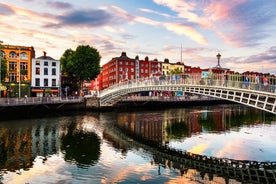 Photo of Colorful row houses with towering cathedral in background in the port town of Cobh, County Cork, Ireland.