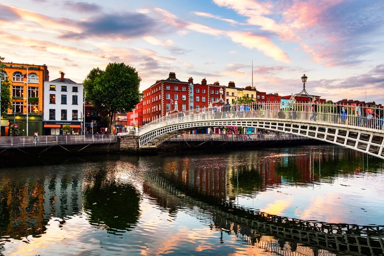 photo of view of Dublin, Ireland. Night view of famous illuminated Ha Penny Bridge in Dublin, Ireland at sunset,Dublin Ireland.