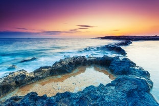 Photo of Seaside cliffs, colourful houses and streets of Qawra town in St. Paul's Bay area in the Northern Region, Malta.