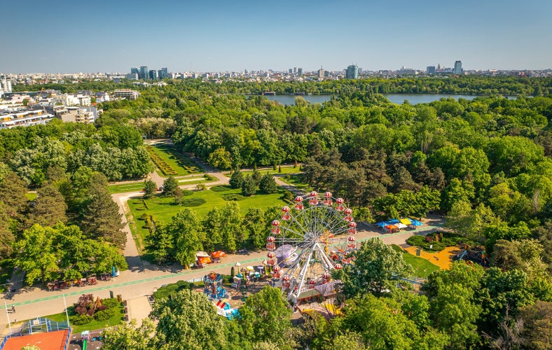 Bucharest from above, aerial view over Herastrau (King Michael I) Park, lake and the north part of the city with office building photographed during a summer sunny day.