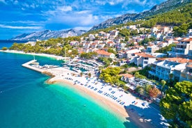 Photo of panorama and landscape of Makarska resort and its harbour with boats and blue sea water, Croatia.