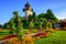 Photo of The medieval Clock tower Uhrturm in flower garden on Shlossberg hill, Graz, Austria.