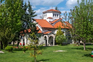 Photo of Saint Anastasia Island in Burgas bay, Black Sea, Bulgaria. Lighthouse tower and old wooden buildings on rocky coast.