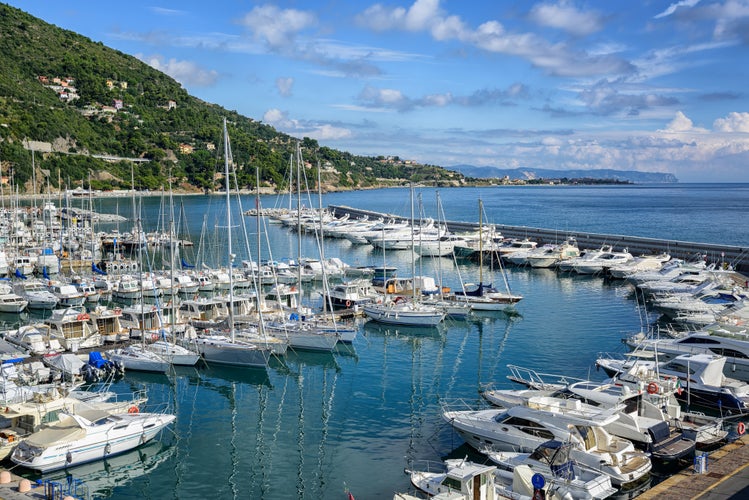 Photo of white yachts docked in Mediterranean port of Alassio on Italian Riviera, Liguria, Italy.