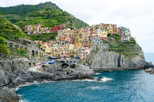 Photo of Riomaggiore with colorful houses along the coastline, one of the five famous coastal village in the Cinque Terre National Park, Liguria, Italy.