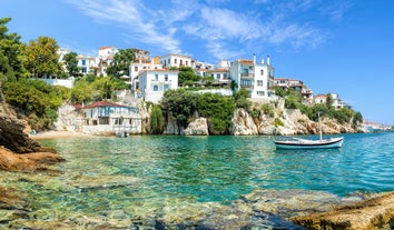 Photo of beautiful aerial view of the old town Skiathos with boats in the harbor, on Skiathos Island, Greece. 