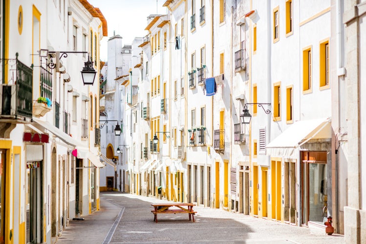 Photo of Street view with beautiful old residential buildings in Evora city in Portugal.