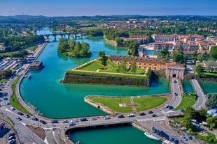 Photo of aerial view of Verona historical city centre, Ponte Pietra bridge across Adige river, Verona Cathedral, Duomo di Verona, red tiled roofs, Veneto Region, Italy.