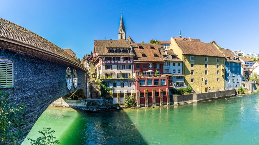 Photo of Switzerland city Baden with Wood Bridge over Limmat river.