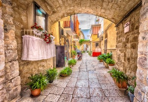 Photo of panoramic view of the ancient town of Matera (Sassi di Matera), European Capital of Culture 2019, in beautiful golden morning light with blue sky and clouds, Basilicata, southern Italy.