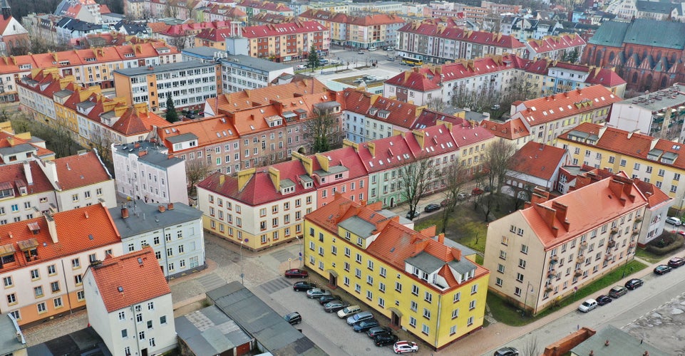 Aerial view on old town center with City Hall, Cathedral and red roof tenements buildings