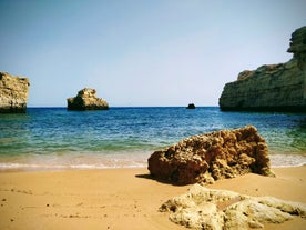 Photo of wide sandy beach in white city of Albufeira, Algarve, Portugal.