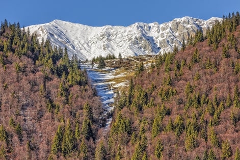Photo of Piatra Craiului mountains peaks covered by snow, Brasov county, Romania.