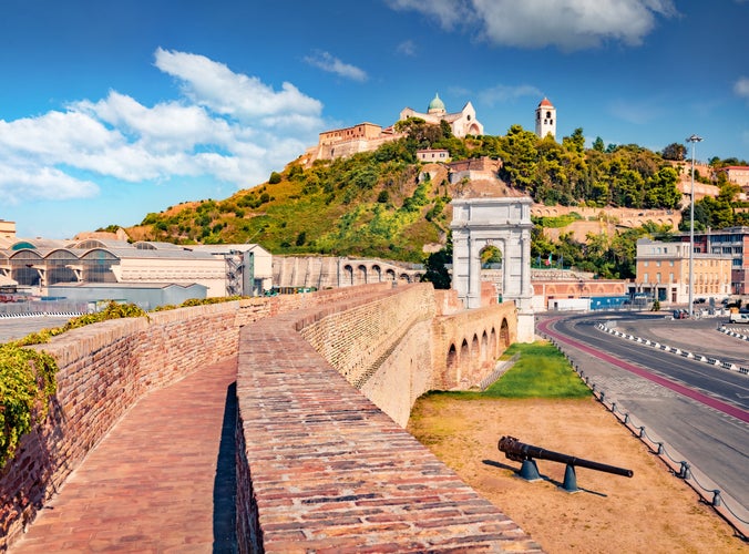 Photo of Wonderful view of Arch of Trajan and Cattedrale di San Ciriaco church on background. Sunny summer cityscape of Ancona town, Italy, Europe. Traveling concept background.