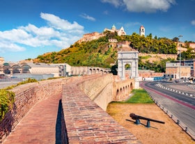 Photo of aerial view of Verona historical city centre, Ponte Pietra bridge across Adige river, Verona Cathedral, Duomo di Verona, red tiled roofs, Veneto Region, Italy.