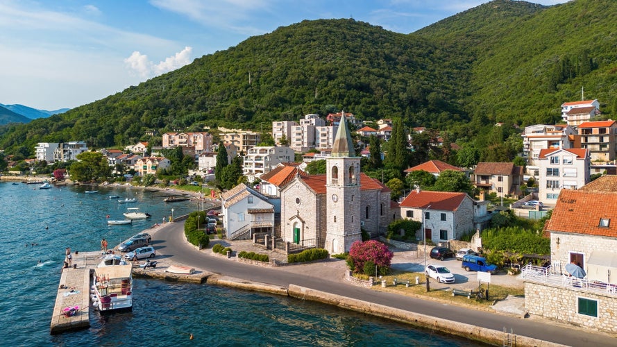 Photo of aerial view of the waterfront orthodox church of Saint Roch of Donja Lastva in Tivat in the Bay of Kotor, Montenegro.