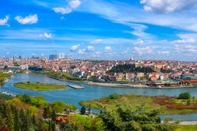 Touristic sightseeing ships in Golden Horn bay of Istanbul and mosque with Sultanahmet district against blue sky and clouds. Istanbul, Turkey during sunny summer day.