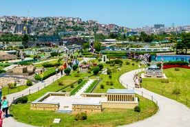 Touristic sightseeing ships in Golden Horn bay of Istanbul and mosque with Sultanahmet district against blue sky and clouds. Istanbul, Turkey during sunny summer day.