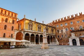 Photo of aerial view of Verona historical city centre, Ponte Pietra bridge across Adige river, Verona Cathedral, Duomo di Verona, red tiled roofs, Veneto Region, Italy.