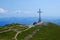 Photo of Caraiman Cross and Busteni city in the background, the tallest summit cross in the world situated at such an altitude, Caraiman Peak in Bucegi mountains, Prahova, Romania .