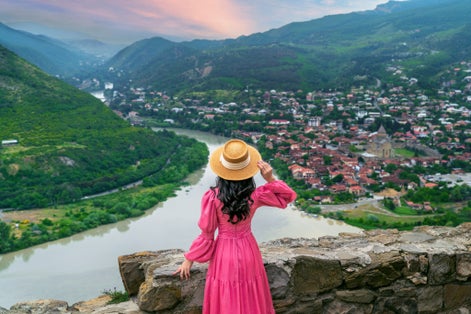 Photo of tourist visiting Jvari Monastery and Mtskheta city in Georgia.