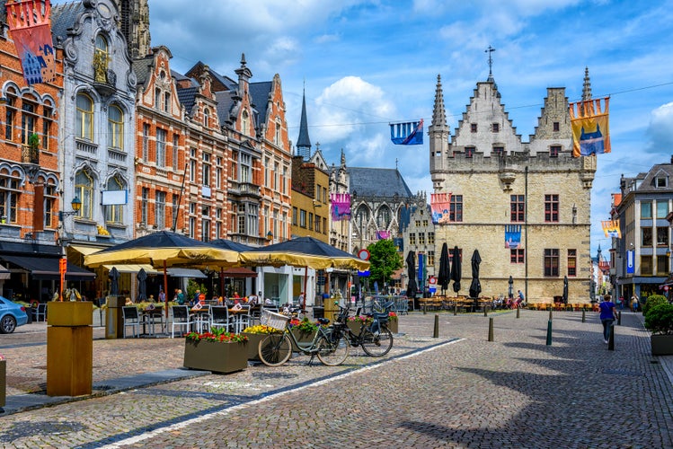 Old street with tables of cafe in Mechelen, Belgium. Mechelen is a city and municipality in the province of Antwerp, Flanders, Belgium.