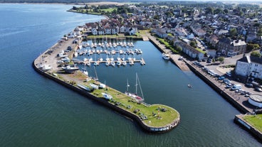 Photo of aerial view of Aberdeen as River Dee flows in a curve to the North Sea showing Duthie Park with bridge and traffic from south.