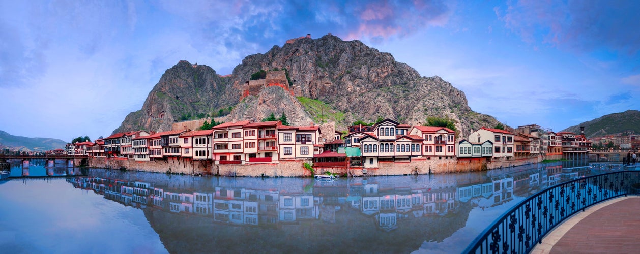 Amasya,TURKEY old riverside Turkish(ottoman) city buildings and its reflection on water,sunny summer day.Amasya is city of princes of ottoman. ottoman Princes were educated in Amasya