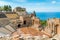 photo of Ruins of the Ancient Greek Theater in Taormina on a sunny summer day with the mediterranean sea. Province of Messina, Sicily, southern Italy.