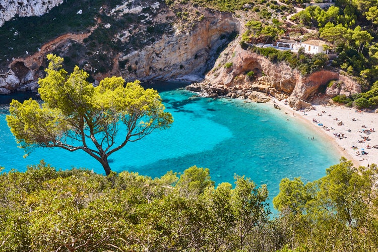 Photo of Spanish mediterranean sunny scenic coastline. La Granadella beach. Alicante, Valencia.