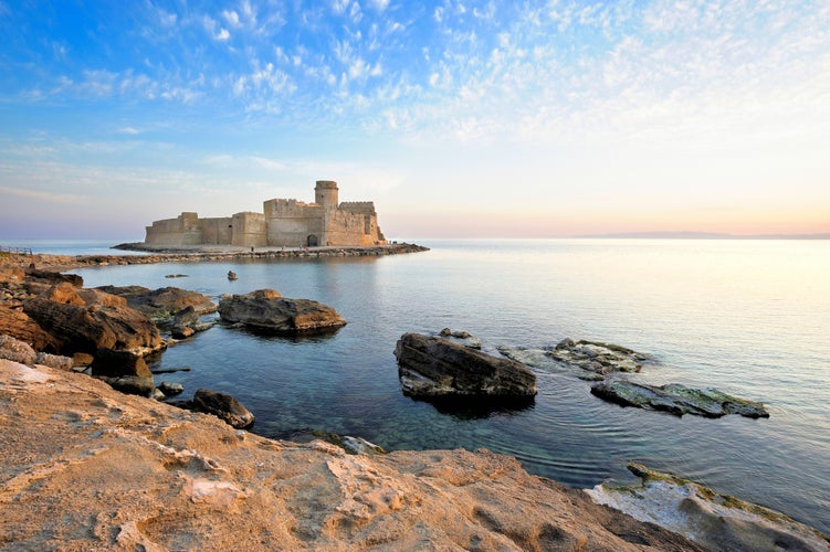 Photo of Isola di Capo Rizzuto, Crotone district, Le Castella, Italy, Calabria, view of the Aragonese castle at sunset.