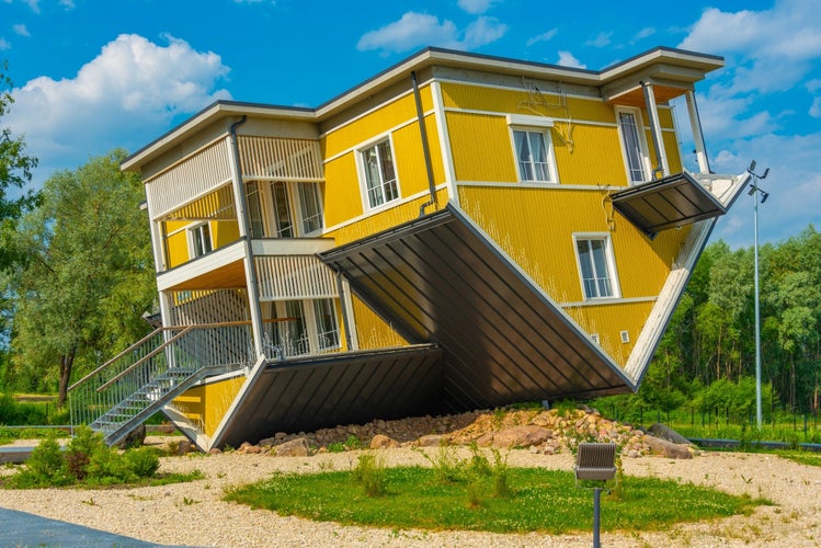 Tagurpidi Maja - a yellow house flipped upside down in Estonain town Tartu.