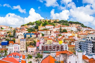 Photo of beautiful aerial view of the sandy beach surrounded by typical white houses in a sunny spring day, Carvoeiro, Lagoa, Algarve, Portugal.