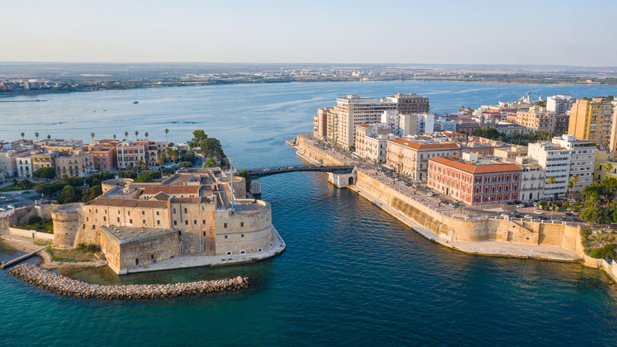 Beautiful panoramic aerial view photo from flying drone on Old medieval Aragonese Castle on sea channel, old town of Taranto city, Puglia (Apulia), Italy (Series)