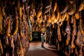 Tour through the Iberian ham drying room and Seville - pick up at the Hotel