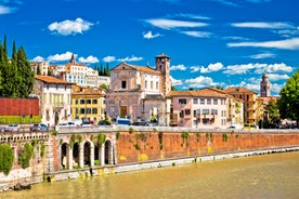 Photo of aerial view of Verona historical city centre, Ponte Pietra bridge across Adige river, Verona Cathedral, Duomo di Verona, red tiled roofs, Veneto Region, Italy.