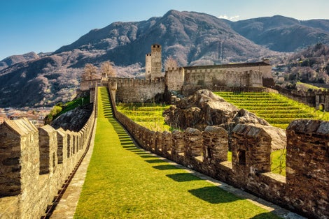 photo of walls and towers of Castelgrande castle in Bellinzona city in the Alps mountains, Ticino, Switzerland.