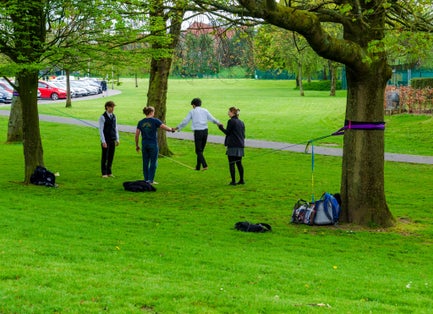 People practicing tightrope walking in Botanic Gardens in Belfast County Down.